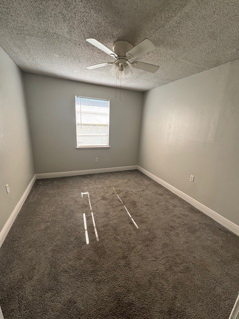 A room with a ceiling fan and a window.